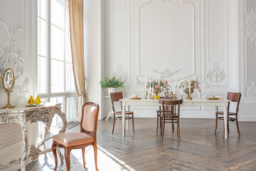 royal baroque style luxury posh interior of large room. extra white, full of day light. high ceiling and walls decorated by stucco