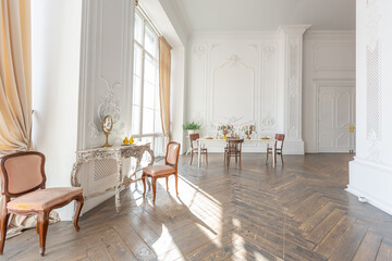 royal baroque style luxury posh interior of large room. extra white, full of day light. high ceiling and walls decorated by stucco