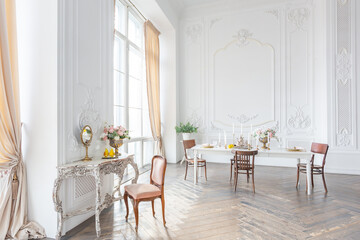 royal baroque style luxury posh interior of large room. extra white, full of day light. high ceiling and walls decorated by stucco