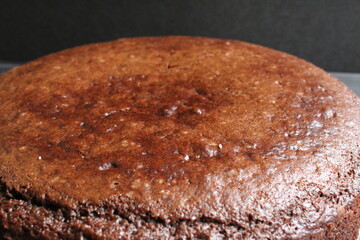 dark chocolate brownie pie close up with copy space on a black gray dark background