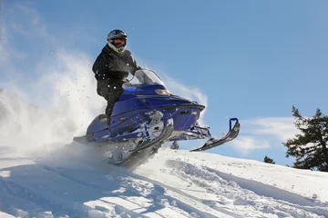 Fotobehang extreme snowmobile rider racing machine through powder in mountains © Nathan Allred