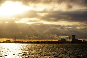 Fototapeta premium Industrial area view from the water, in the morning sun Moerdijk in the Netherlands, Brabant's work area.