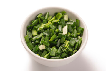Green onion feathers chopped in a bowl isolated on white background, close up