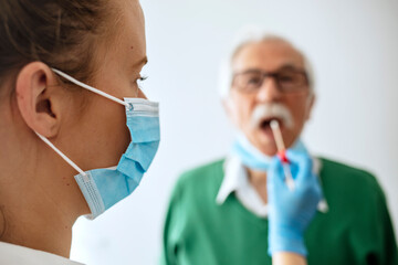 Closeup of female lab taking a nasal culture sample with a swab in order to perform biochemical...