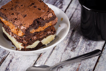 Chocolate brownie with milk powder delicious filling. Closeup photography.