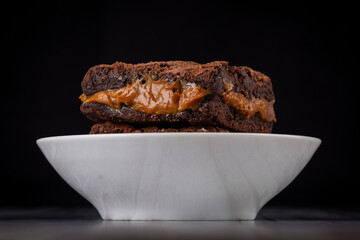Chocolate brownie with milk powder delicious filling. Closeup photography.