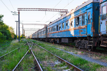 Old, rusty and abandoned passenger cars on the spare track