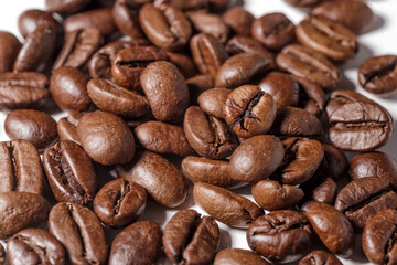 Freshly roasted coffee beans background.Dark roasted coffee beans with scoop on wooden background.