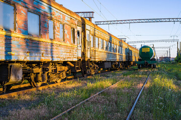 Old, rusty and abandoned passenger cars on the spare track