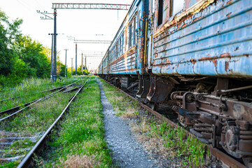 Old, rusty and abandoned passenger cars on the spare track - obrazy, fototapety, plakaty
