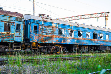 Old, rusty and abandoned passenger cars on the spare track