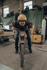 vintage motorcyclist, vintage motorcycle in the garage