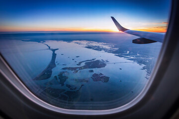 Aerial view of Venice from airplane window. View of Venezia and the Venetian Lagoon from the height of bird flight at sunset. Postcard view.