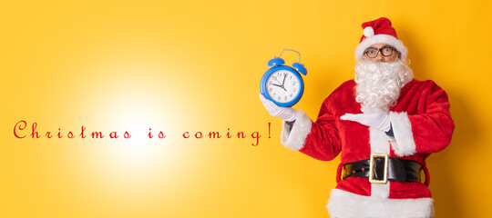 isolated santa claus with clock announcing christmas