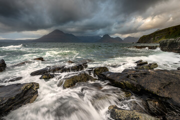 Crashing waves at Elgol on the Isle of Skye with Cuillin Range in the background. 