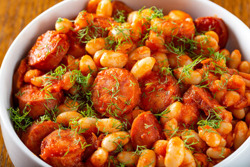 Beans stew with pork sausages