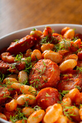 Beans stew with pork sausages