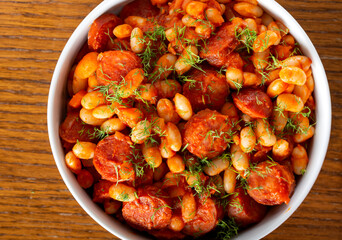 Beans stew with pork sausages