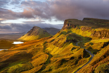 Morning light at The Quiraing on the beautiful Scottish Isle of Skye with winding road.