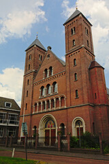 Fototapeta na wymiar Old masonry church with towers in Utrecht, the NEtherlands
