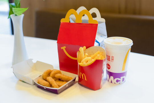 Happy Meal menu at McDonald's restaurant. Happy Meal Kids Next to Cheeseburger, Drink and Chicken McNuggets. Time for a snack, lunch, breakfast. Children's menu. , Salzburg , Austria - October 2020