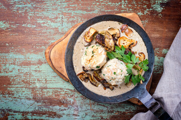 Modern style traditional German cooked porcini mushroom soup with pretzel dumpling and fried potato...
