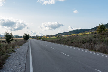 Country road through rural hillside autumn typical scene village asphalt farming ground trasnport