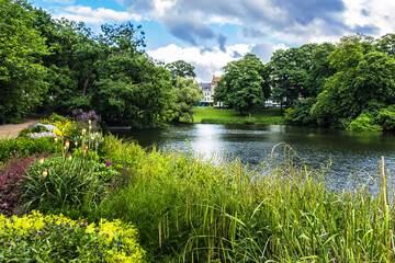Fototapeta premium View of Orsted park (Orstedsparken, 1879) - a public park in central Copenhagen. Orsted Park is one in a series of parks which laid out on grounds of old fortification ring. Copenhagen, Denmark.