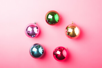 Christmas New Year composition. Gifts, colorful ball decorations on pink background. Winter holidays concept. Flat lay, top view