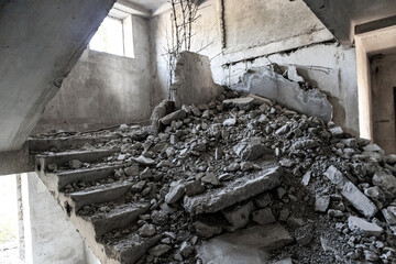 Crashed concrete staircase inside abandoned ruined floor of soviet building. Unfinished city of...
