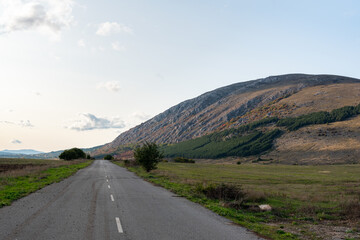 Country road through rural hillside autumn typical scene village asphalt farming ground trasnport