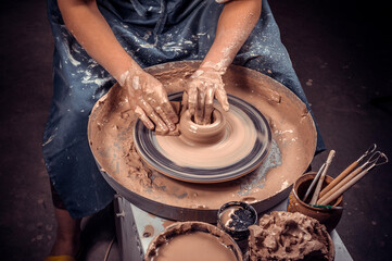 Creating a jar or vase. Master crock. Making clay jug. The sculptor in the workshop makes a jug out...