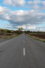 Country road through rural hillside autumn typical scene village asphalt farming ground trasnport