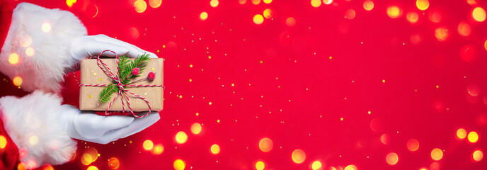 Santa Claus Give Handmade Present In Red Background - Christmas