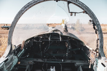 Inside pilot cabin of military plane with broken front windscreen. Aero L-29 Delfín a jet-powered trainer aircraft at abandoned Airbase remains in Vovchansk, Ukraine