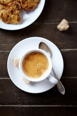 Cup of coffee on rustic wooden background. Top view.	