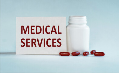 On a light blue background a card with the text MEDICAL SERVICES near the white bottle pills