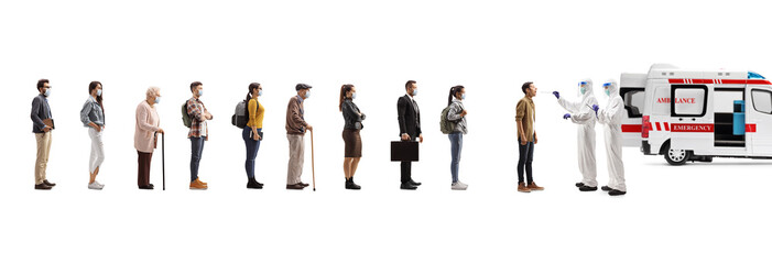 Ambulance vehicle and doctors in a hazmat suits testing people in a queue for covid-19