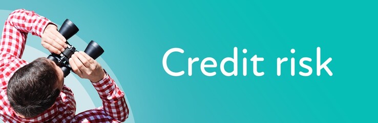 Credit risk. Man observing with binoculars. Focus on text/word. Panorama format. Blue/turquoise...