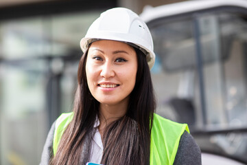 young construction engineer woman with helmet working outside
