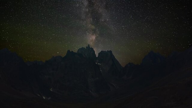 Time Lapse. Beautiful View of Dramatic Mountains during Fall in Canadian Nature. Night Sky with Milky Way Artistic Render. Aerial Shot. Taken in Tombstone Territorial Park, Yukon, Canada.