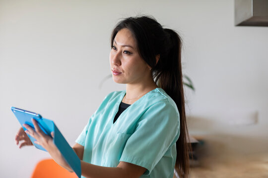 young nurse woman looking  with a tablet in a  doctor's office