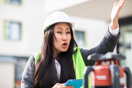 Young Construction Engineer Woman With Helmet Working Outside