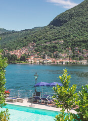 summer holidays in a renowned tourist resort. swimming pool overlooking the Como lake. summer season in Lombardy. italy