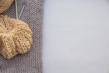 Fototapeta na wymiar A ball of woolen thread with knitting needles and an English knitting pattern lie on a white background by the window