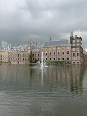 Fototapeta premium The Hague's Binnenhof with the Hofvijver. Dutch Senate and House of Representatives (Parliament) building with running fountain in the pond at the front. Den Haag / Netherlands.