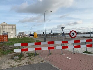 Barriers and signs to indicate closed bike lane and sidewalk. Road work ahead. Detour for bicycles. Pedestrians not allowed. No access. Vlissingem, Zeeland, Netherlands.