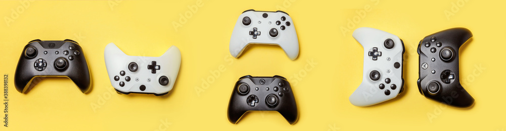 Canvas Prints white and black many joystick gamepad game console isolated on yellow colourful trendy background. c