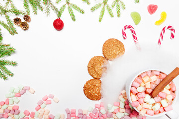 Cup of hot aromatic chocolate drink with marshmallows on a white background, Christmas decorations. A drink for the winter. Flat lay. Copy space.