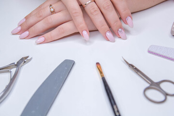 Obraz na płótnie Canvas Perfect light nail manicure. Beauty saloon. Gel polish concept. 